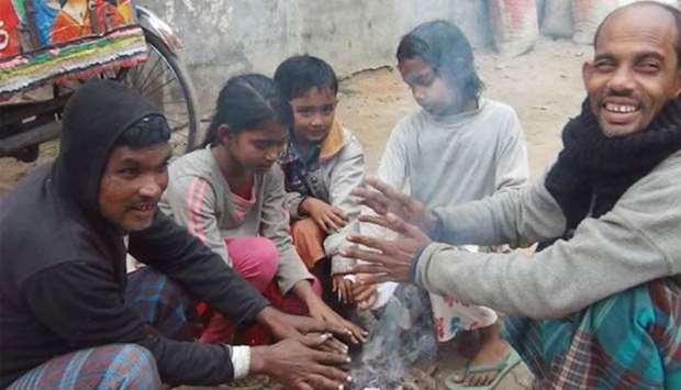 People warm their hands as a cold wave grips Bangladesh. Picture: Dhaka Tribune