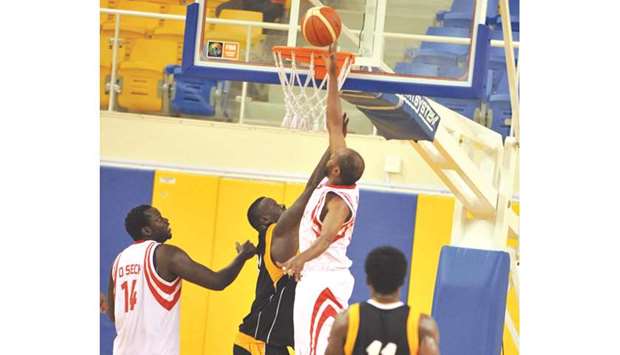 Al Arabi (in white and red) and Qatar Sports Club players in action during their Qatar Basketball League match yesterday.
