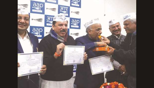 AAP leaders Sanjay Singh, N D Gupta and Sushil Gupta show their u2018Certificate of Electionu2019 after being elected unopposed to the Rajya Sabha in New Delhi yesterday.