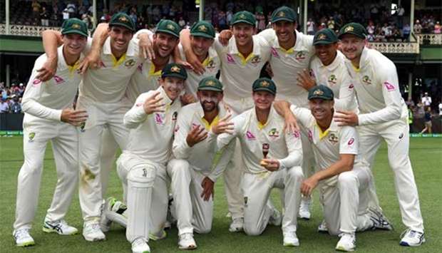 Australia's cricket team celebrates after retaining the Ashes trophy, defeating England on the final day of the fifth Ashes Test at the SCG in Sydney on Monday.