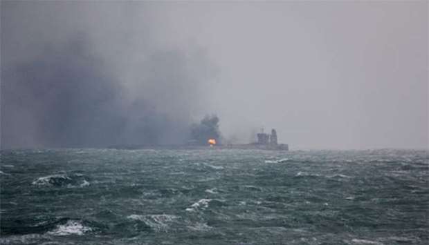Smoke is seen from Panama-registered Sanchi tanker carrying Iranian oil that caught fire after it collided with a Chinese freight ship in the East China Sea, on Tuesday.