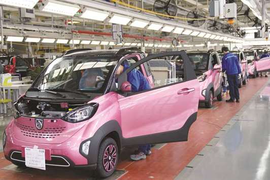 Workers inspect Baojun E100 all-electric battery cars at a final assembly plant operated by General Motors and its China joint-venture partner in Liuzhou, Guangxi Zhuang Autonomous Region. GM said last week that its China sales grew 4.4% last year, following a 7.1% rise in 2016.