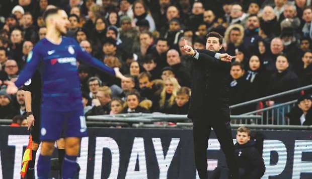Tottenham Hotspuru2019s coach Mauricio Pochettino (right) gestures as Chelseau2019s midfielder Eden Hazard reacts during the League Cup semi-final in London. (AFP)