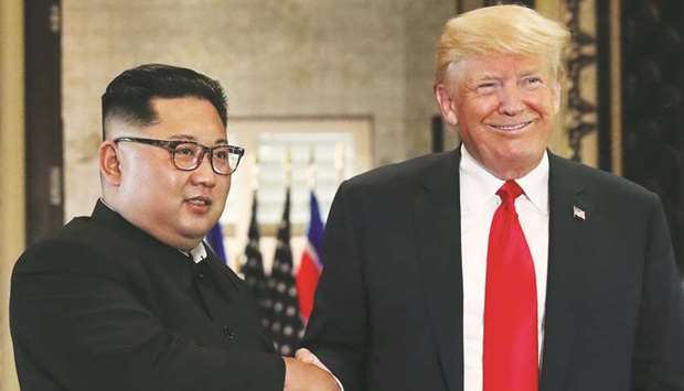 US President Donald Trump and North Koreau2019s leader Kim Jong-un shake hands after signing documents during a summit at the Capella Hotel on the resort island of Sentosa, Singapore on June 12.