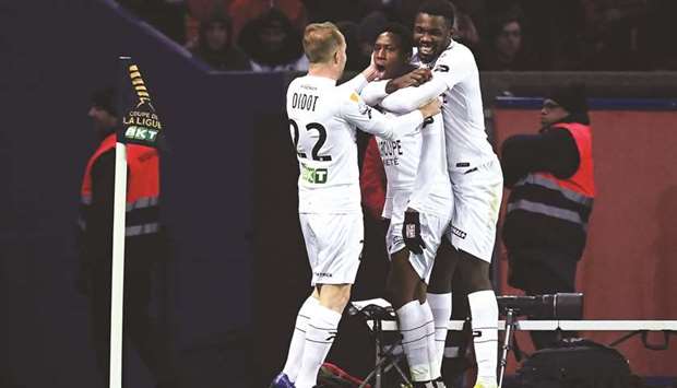 Guingampu2019s Yeni Ngbakoto (centre) celebrates with teammates after scoring against Paris Saint-Germain in the French League Cup quarter-finals. (AFP)