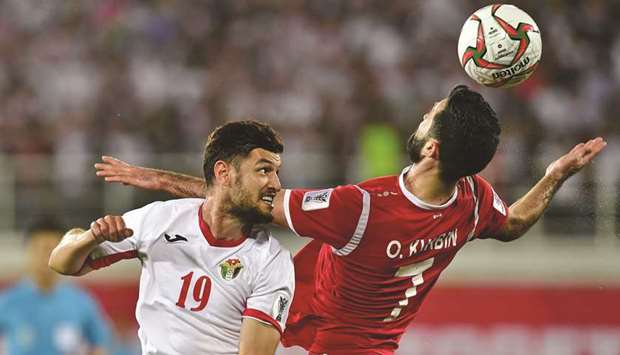 Jordanu2019s defender Anas Bani Yaseen (L) vies for the ball with Syriau2019s forward Omar Khrbin during their Asian Cup match in Al Ain yesterday.