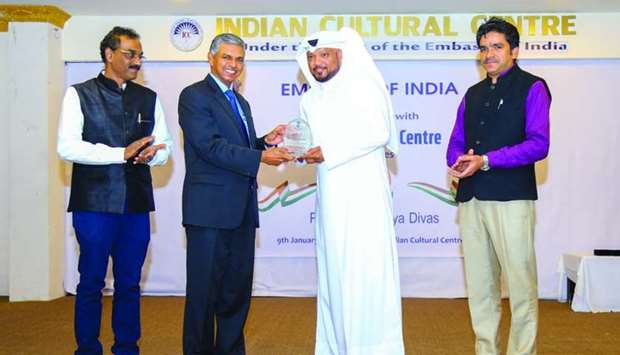 Qatar-based singer Ahmed Abdulrahim receiving a plaque of appreciation from Indian ambassador P Kumaran as ICC officials look on.