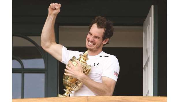 In this file photo taken on July 10, 2016 Britainu2019s Andy Murray poses with the  trophy after winning the Wimbledon title.