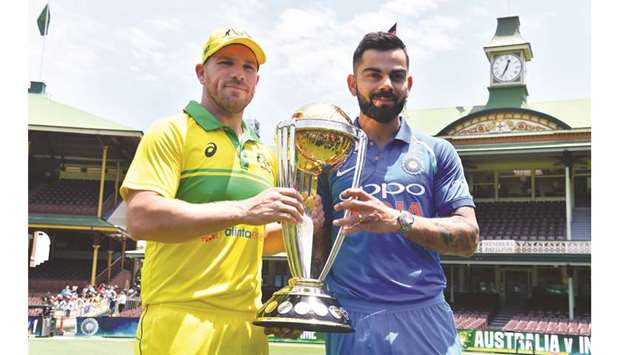 Australian captain Aaron Finch (left) and his Indian counterpart Virat Kohli pose with the ICC Cricket World Cup trophy at the Sydney Cricket Ground in Sydney yesterday. (AFP)