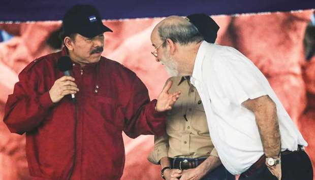 This file photo taken on July 07, 2017 shows President Ortega (left) speaking with Solis in Managua, during the celebration of the 38th anniversary of u2018El Repliegueu2019 (The Fall Back) tactical retreat from Managua to Masaya, at Victoria Square in Managua.