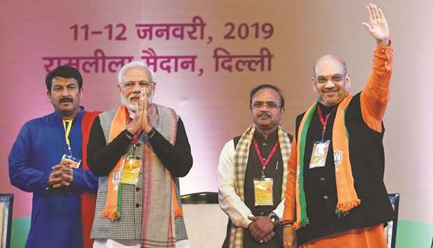 Indian Prime Minister Narendra Modi (second left) and Bharatiya Janata Party (BJP) president Amit Shah, right, gesture as they arrive on the first day of the two-day Bharatiya Janata Party national convention in New Delhi yesterday.