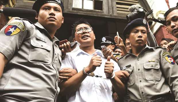 Myanmar journalist Wa Lone is escorted by police to jail in Yangon in a file picture.
