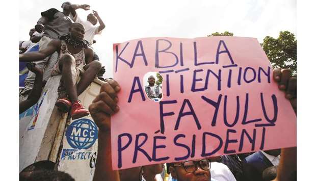 Supporters of the runner-up in Democratic Republic of Congou2019s presidential election, Martin Fayulu hold a sign before a political rally in Kinshasa, yesterday.