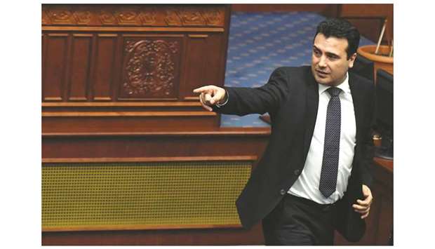 Zaev gestures to the press after deputies of the Macedonian parliament voted to pass constitutional changes to allow the Balkan country to change its name to the Republic of North Macedonia.