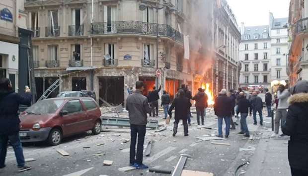 Fire burns at the site of an explosion at a bakery shop in Paris.