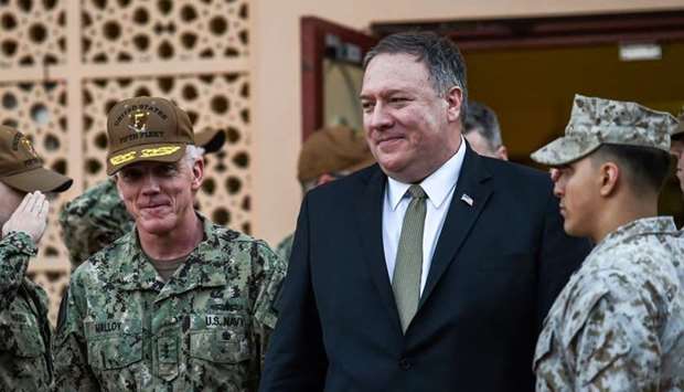 US Secretary of State Mike Pompeo (C) walks with Vice Admiral James Malloy (L), commander of the US Naval Forces Central Command.