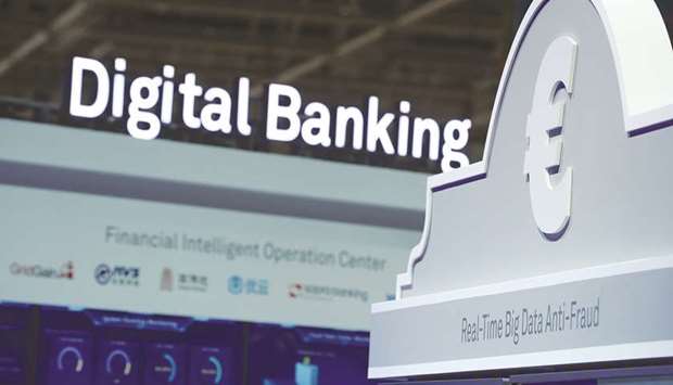 A euro symbol sits on a digital banking exhibition at the Huawei Technologies stand at the CeBIT 2018 tech fair in Hanover, Germany (file). Blockchain, an unalterable digital information recording system, is increasingly being discovered as a useful tool by Islamic finance institutions and banks for complex financing contracts and Shariah-compliant transactions, as well as to drive innovation in the industry.