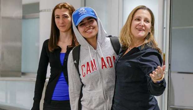 Rahaf Mohammed al-Qunun (C) accompanied by Canadian Minister of Foreign Affairs Chrystia Freeland (R) and Saba Abbas, general counsellor of COSTI refugee service agency, arrives at Toronto Pearson International Airport in Toronto, Ontario, Canada