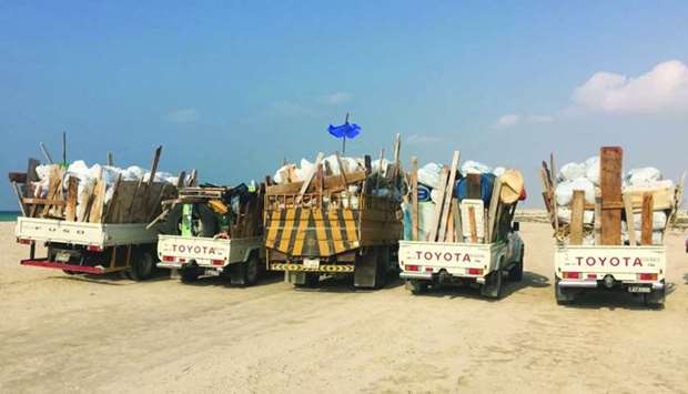 Trucks loaded with waste materials collected during the campaign.