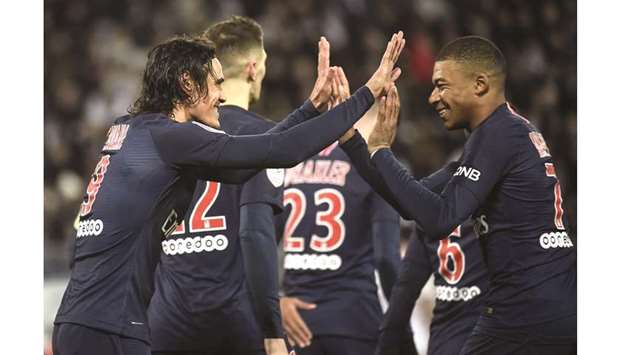 Paris Saint-Germainu2019s Edinson Cavani (left) is congratulated by teammate Kylian Mbappe after scoring during the Ligue 1 match against Amiens at the Licorne stadium in Amiens yesterday. (AFP)