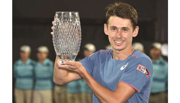 Australiau2019s Alex De Minaur holds the winneru2019s trophy after beating Andreas Seppi of Italy in the final of the Sydney International yesterday.