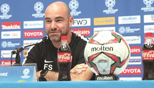 Confident: Qatar coach Felix Sanchez speaks at his pre-match press conference in Al Ain yesterday. At bottom, captain Hassan al-Haydos (L) leads a team training session.