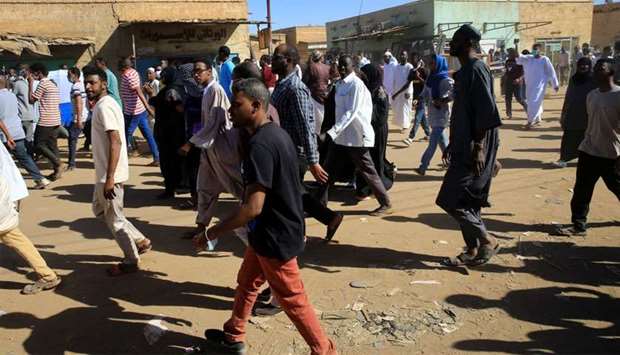 Sudanese demonstrators march along the street during anti-government protests after Friday prayers in Khartoum