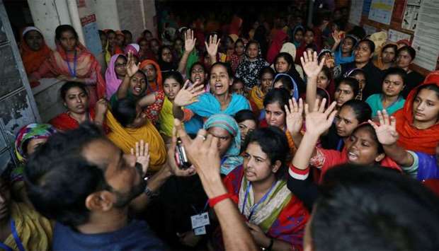 Garment workers shout as they protest for higher wages in Dhaka