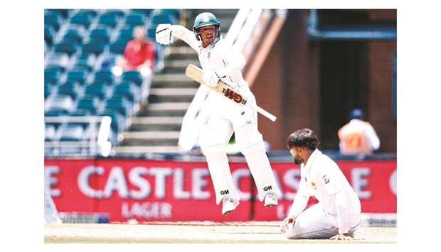 South Africau2019s Quinton de Kock (left) jumps to celebrate his century (100 runs) on third day of the third Test against Pakistan at Wanderers cricket stadium in Johannesburg, South Africa, yesterday. (AFP)