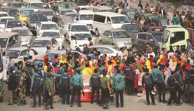 Garment workers block a road as they protest for higher wages in Dhaka, Bangladesh.