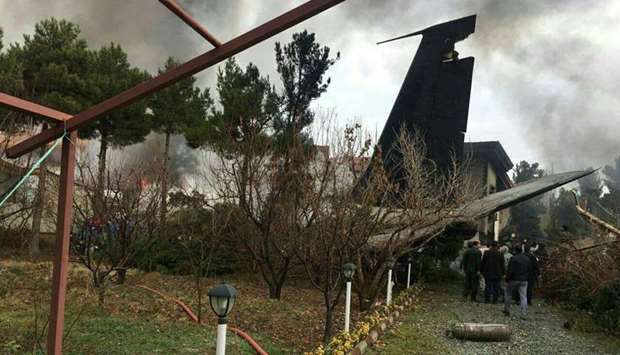 A photo being shared on social meidia that shows smoke rising up from the debris of the crashed plane.