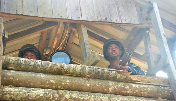 Myanmar border guard police stand guard at Goke Pi outpost in Buthidaung during a government organized media tour in Rakhine, Myanmar on January 7.