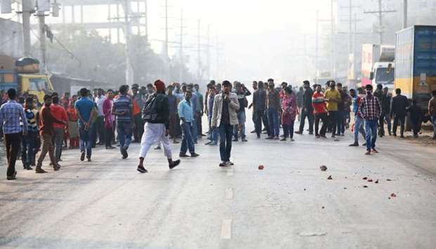 Garment workers block a road as they protest for higher wages at Ashulia, outskirt of Dhaka