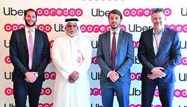 Senior Ooredoo and Uber executives mark the partnership.rnrn
