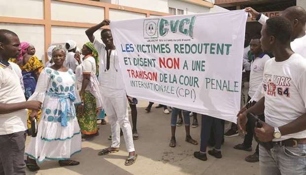 Demonstrators hold a banner reading u201cVictims fear and say no to an ICC treasonu201d as victims and relatives of victims of the 2011 post electoral violence protest against a request to release former Ivory Coastu2019s president Laurent Gbagbo in front of the Human Rights Council offices in Abidjan.