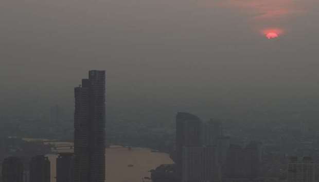 The sunset is seen during a poor air quality day in Bangkok, Thailand.