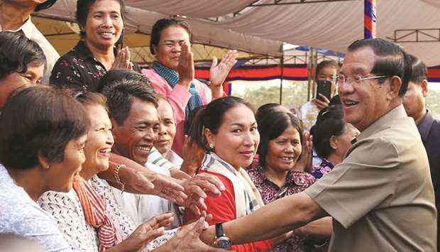 Cambodian Prime Minister Hun Sen greets people during a ground breaking ceremony to build the third ring road in Phnom Penh yesterday.