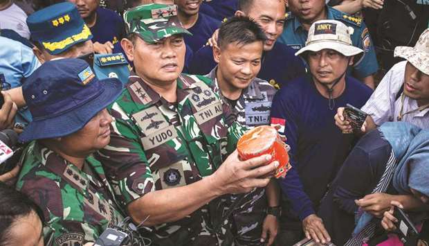 Rear Admiral Yudo Margono holds the cockpit voice recorder (CVR) of a Lion Air JT610 that crashed into Tanjung Karawang sea, on the deck of Indonesiau2019s Navy ship KRI Spica-934 at Karawang sea in West Java, yesterday.