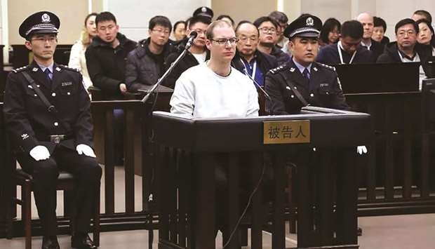 Canadian Robert Lloyd Schellenberg, centre, during his retrial on drug trafficking charges in the court in Dalian in Chinau2019s northeast Liaoning province yesterday.