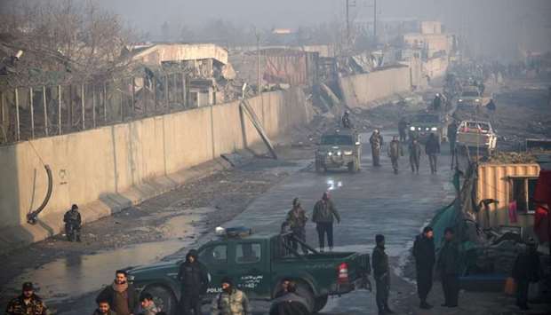 Afghan security forces gather at the site of a powerful truck bomb attack a day after it detonated near a foreign compound in Kabul