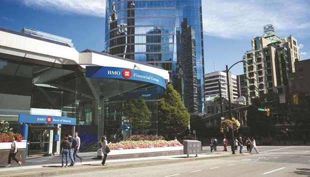 Pedestrians pass in front of a Bank of Montreal branch in Vancouver, British Columbia, Canada. The 15-year-old, Florida-based Islamic wealth manager ShariaPortfolio has clients across 26 states and it hopes to open a Vancouver office in the second quarter of this year to fuel growth, chief executive officer Naushad Virji said.