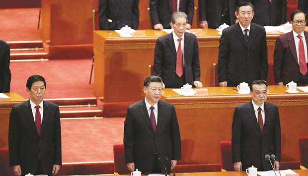 Chinese President Xi Jinping, Premier Li Keqiang and National Peopleu2019s Congress chairman Li Zhanshu sing the national anthem at an event marking the 40th  anniversary of Chinau2019s reform and opening up at the Great Hall of the People in Beijing. Premier Li said China achieved its key 2018 economic targets, which were u201chard-wonu201d, and seeks a strong start in the first quarter to help meet this yearu2019s goals.