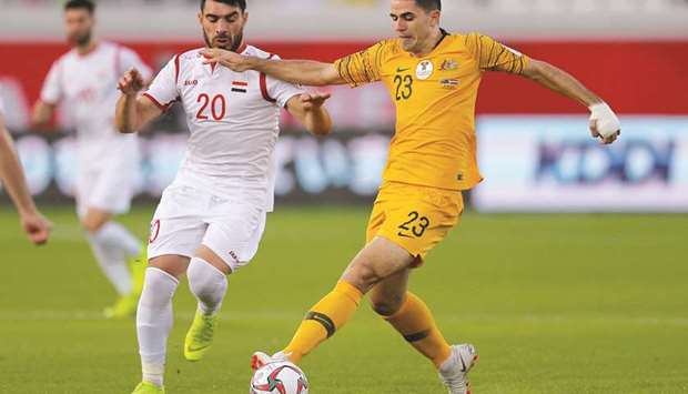 Syriau2019s Khaled al-Mbayed (L) in action with Australiau2019s Tom Rogic during their Asian Cup match yesterday.