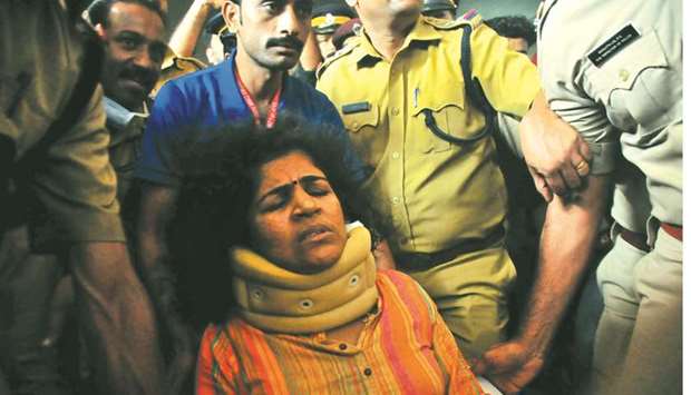 Kanaka Durga being escorted by police at a hospital in Manjeri town, Kerala.