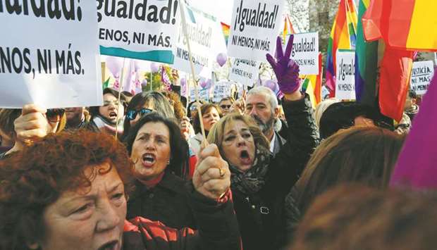 Womenu2019s rights groups members shout slogans during their protest in Seville against the Andalusia government.