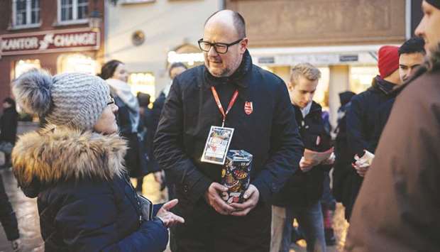 This picture taken on Sunday shows Adamowicz speaking with people as he collects money for the Great Orchestra of Christmas Charity in Gdansk.