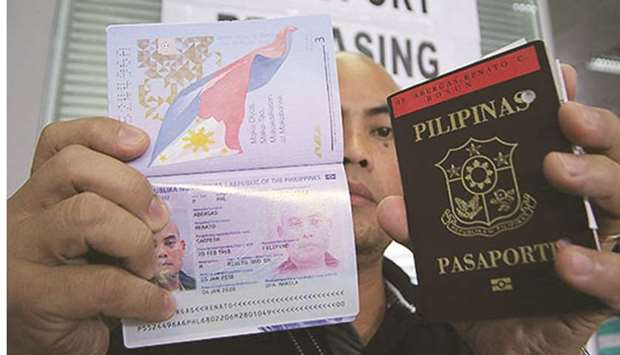 A man shows his newly released passport at the Department of Foreign Affairs office in Pasay City.