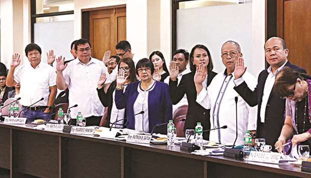 Sorsogon Mayor Edwin Hamor (left) and other Sorsogon officials swear before testifying during the inquiry on infrastructure projects at the House of Representatives.