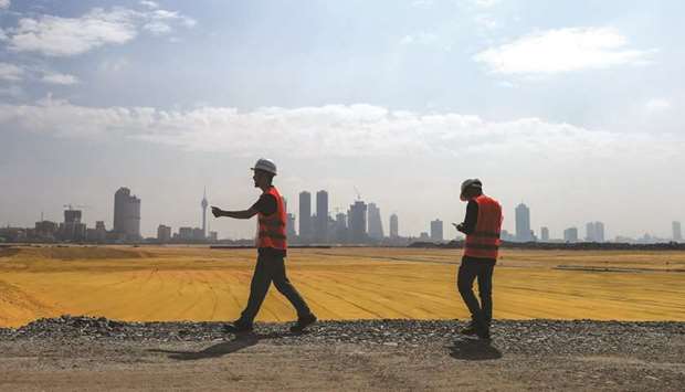 Chinese labourers walk as they work in a construction site of a Chinese-funded $1.4bn land reclamation project in Colombo yesterday.