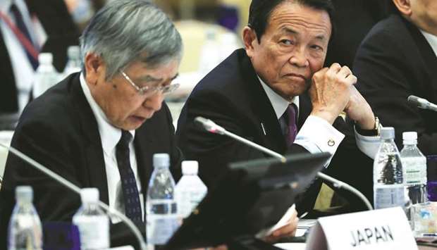 Japanu2019s Finance Minister Taro Aso and Bank of Japan governor Haruhiko Kuroda attend the G20 Finance and Central Bank Deputies meeting in Tokyo. Aso warned that  protectionism and unfair trade practices would undermine economic stability.